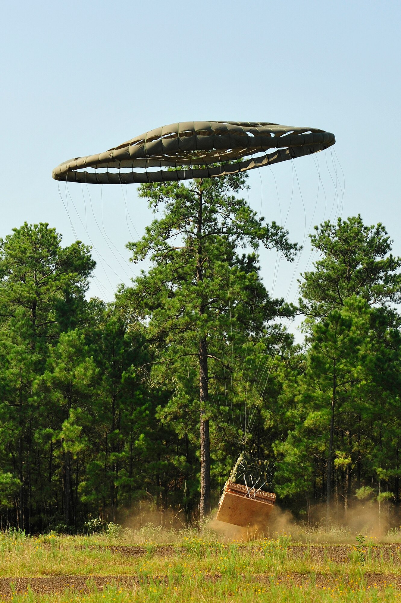 FORT POLK, La. – A bundle attached to a high-speed parachute bounces after impacting the ‘Strike’ Drop Zone at Fort Polk, La., Aug. 17, 2013. The package was delivered by a Canadian Royal Air Force C-130J Hercules during a joint airdrop training mission with the Royal New Zealand Air Force and U.S. Air Force. (U.S. Air Force photo by Tech. Sgt. Parker Gyokeres)(Released)