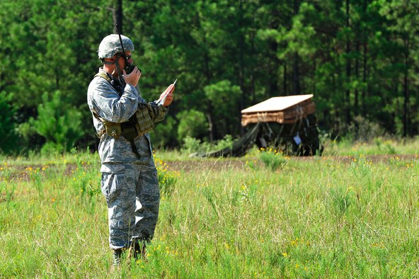 Maj. Mike Welch, an air mobility liaison officer from the 621st Contingency Response Wing, Joint Base McGuire-Dix-Lakehurst, N.J., assigned to the U.S. Army’s 1st Theatre Sustainment Command at Fort Bragg, N.C., calls in drop zone instructions to a waiting C-130 Hercules circling over the ‘Strike’ Drop Zone at Fort Polk, La., Aug. 17, 2013 during Joint Readiness Training Center rotation 13-09. Air Mobility Command AMLOs are rated pilots or navigators assigned to U.S. Army and Marine units who coordinate with their joint and coalition partners for air mobility services provided by the U.S Air Force. (U.S. Air Force photo/Tech. Sgt. Parker Gyokeres)
