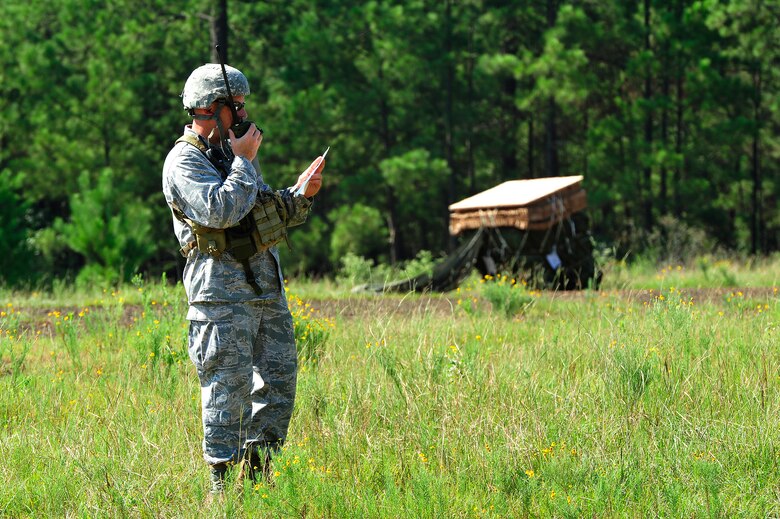 FORT POLK, La. – U.S. Air Force Major Mike Welch, an air mobility liaison officer from the 621st Contingency Response Wing, Joint Base McGuire-Dix-Lakehurst, N.J., assigned to the U.S. Army’s 1st Theatre Sustainment Command at Fort Bragg, N.C., calls in drop zone instructions to a waiting C-130 Hercules circling over the ‘Strike’ Drop Zone at Fort Polk, La., Aug. 17, 2013 during Joint Readiness Training Center rotation 13-09. Air Mobility Command AMLOs are rated pilots or navigators assigned to U.S. Army and Marine units who coordinate with their joint and coalition partners for air mobility services provided by the U.S Air Force.  (U.S. Air Force photo by Tech. Sgt. Parker Gyokeres)(Released)