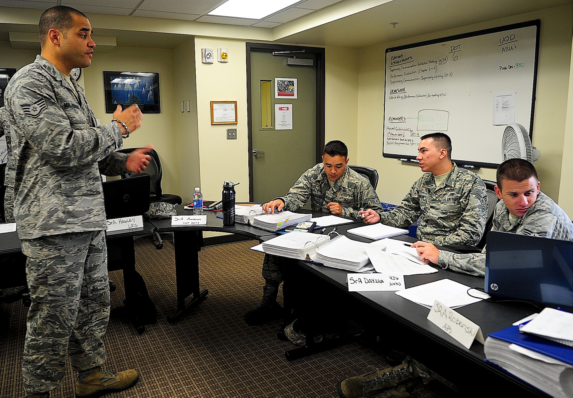 Staff Sgt. Luis Maldonado, Airman Leadership School instructor, discusses the importance of the enlisted evaluation system with three ALS students Aug. 29, 2013, at the ALS building on Dover Air Force Base, Del. ALS instructors teach Airmen the supervisory skills they will need when they are tasked to lead other Airmen. (U.S. Air Force photo/Airman 1st Class Ashlin Federick)