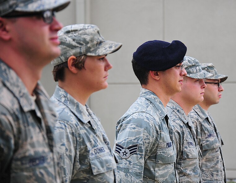 Students in Airman Leadership School class 13-G stand at attention during a drill Aug. 28, 2013, at the ALS building on Dover Air Force Base, Del. ALS students preform reveille and retreat every Friday. (U.S. Air Force photo/Staff Sgt. Elizabeth Morris)