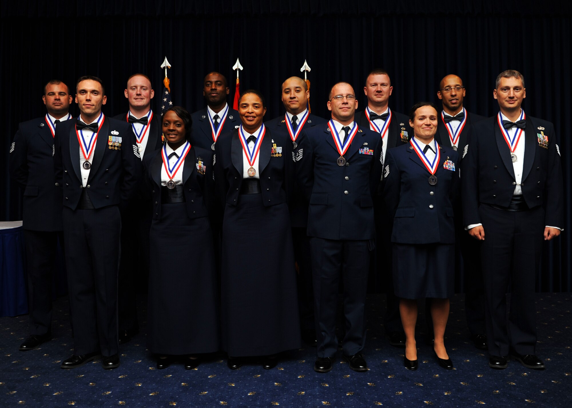 Twelve technical sergeants pose for a photo after being inducted into the senior noncommissioned officer corps Sept. 6, 2013 at the Consolidated Club Complex. More than 150 friends, family members and cooworkers attended to support the inductees. (U.S. Air Force photo by Senior Airman Chase Hedrick/Released)