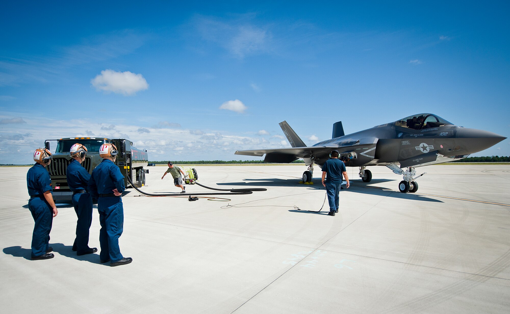 A 96th Test Wing fuels management technician hauls the fuel hose back to the truck after refueling a Navy F-35C Lightning II during a hot pitting session on the 33rd Fighter Wing flightline at Eglin Air Force Base, Fla.  Airmen, Marines and Sailors are refueling their F-35 variants for multiple sorties via 96th Test Wing fuel trucks while construction is completed on the 33rd’s hot pit area.  (U.S. Air Force photo/Samuel King Jr.)