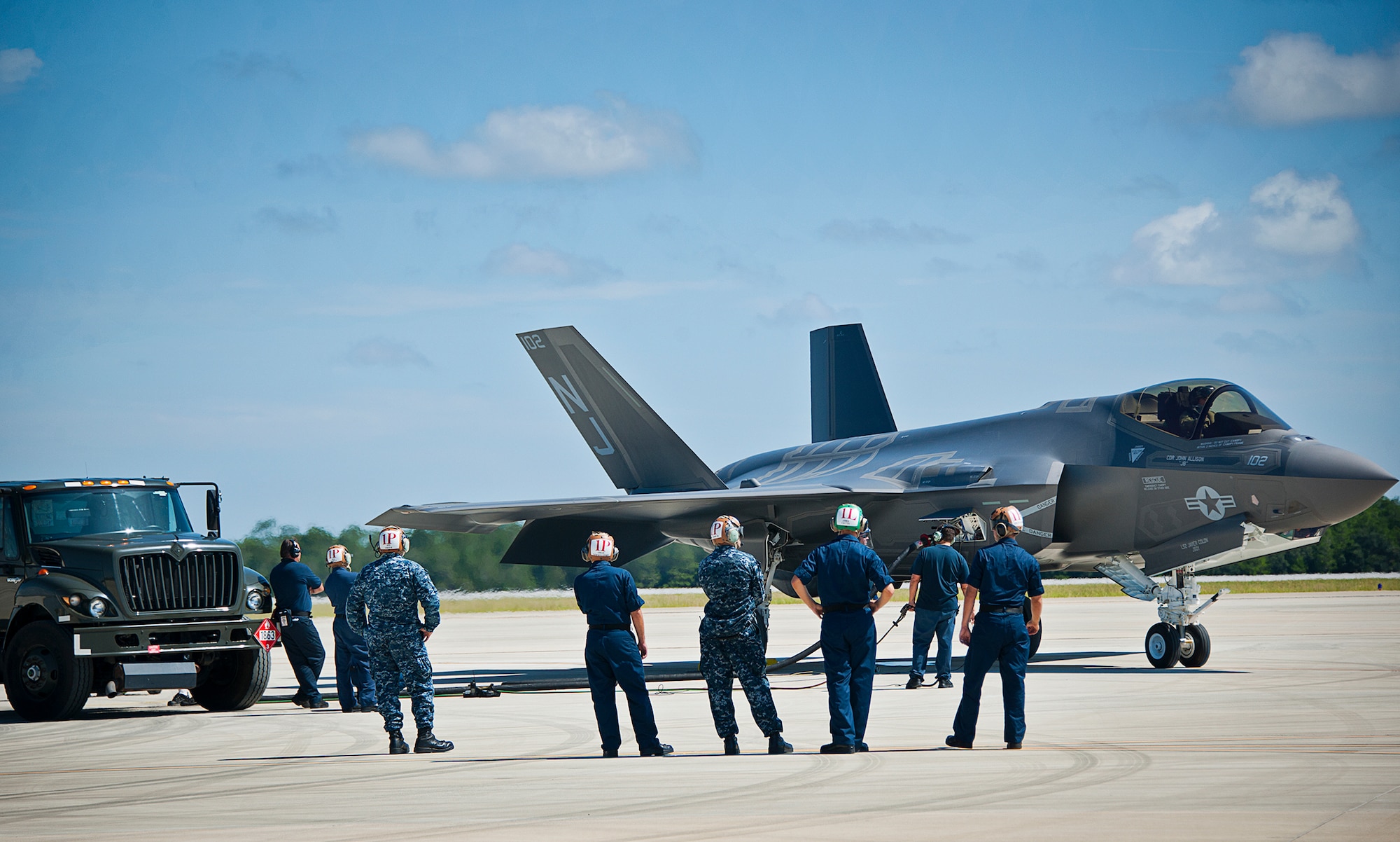 Sailors from Strike Fighter Squadron-101, watch as their F-35C Lightning II is refueled during a hot pit session on the 33rd Fighter Wing flightline at Eglin Air Force Base, Fla.  Airmen, Marines and Sailors are refueling their F-35 variants for multiple sorties via 96th Test Wing fuel trucks while construction is completed on the 33rd’s hot pit area.  (U.S. Air Force photo/Samuel King Jr.)