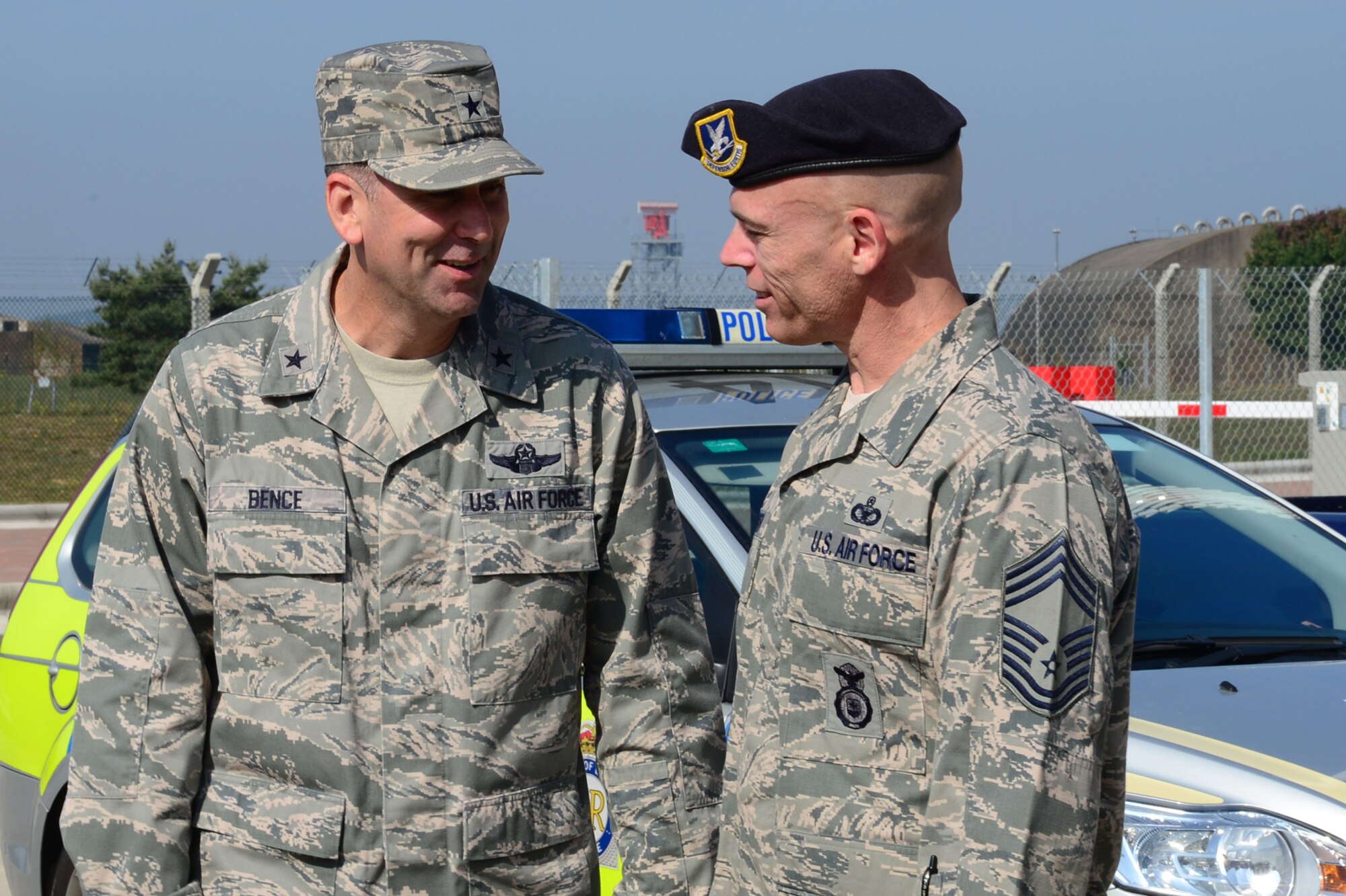Brig. Gen. Christopher Bence, U.S. Air Forces in Europe-United Kingdom director, speaks with Chief Master Sgt. Darrin Hooten, 48th Security Forces Squadron manager, during a base tour on Royal Air Force Lakenheath, England, Sept. 5, 2013. Bence toured RAF Lakenheath and spoke with Airmen to gain a better understanding of the operations they perform on a daily basis. During his immersion tour of the 48th Fighter Wing, the general visited the RAF Lakenheath Hospital, 48th Maintenance Group, 48th Mission Support Group and several other units. As the USAFE-UK director, Bence supports European Command, NATO, USAFE and U.S. Government agencies with thorough planning and partnering with the U.K. (U.S. Air Force photo by Airman 1st Class Dana J. Butler/Released)