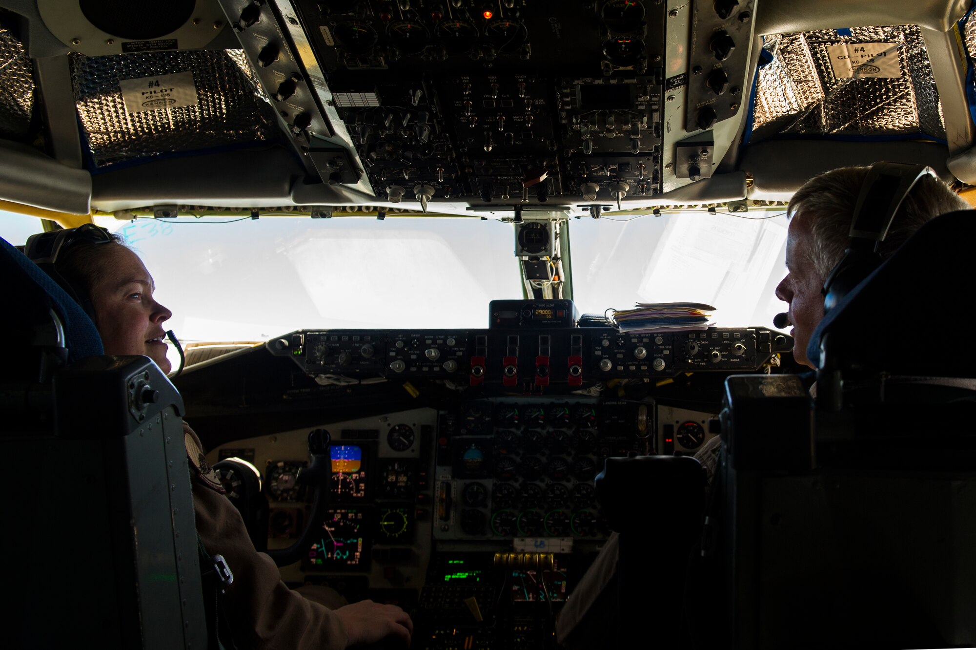U.S. Air Force Maj. Abby Kent and Lt Col Jerry Selig, 340th Expeditionary Air Refueling Squadron KC-135 Stratotanker pilots, talk during an air refueling mission over Afghanistan Sept. 4, 2013. Kent and Selig are deployed from the 756th Air Refueling Squadron, at Andrews Air Force Base in support of Operation Enduring Freedom. (U.S. Air Force photo by SSgt Stephany Richards)
