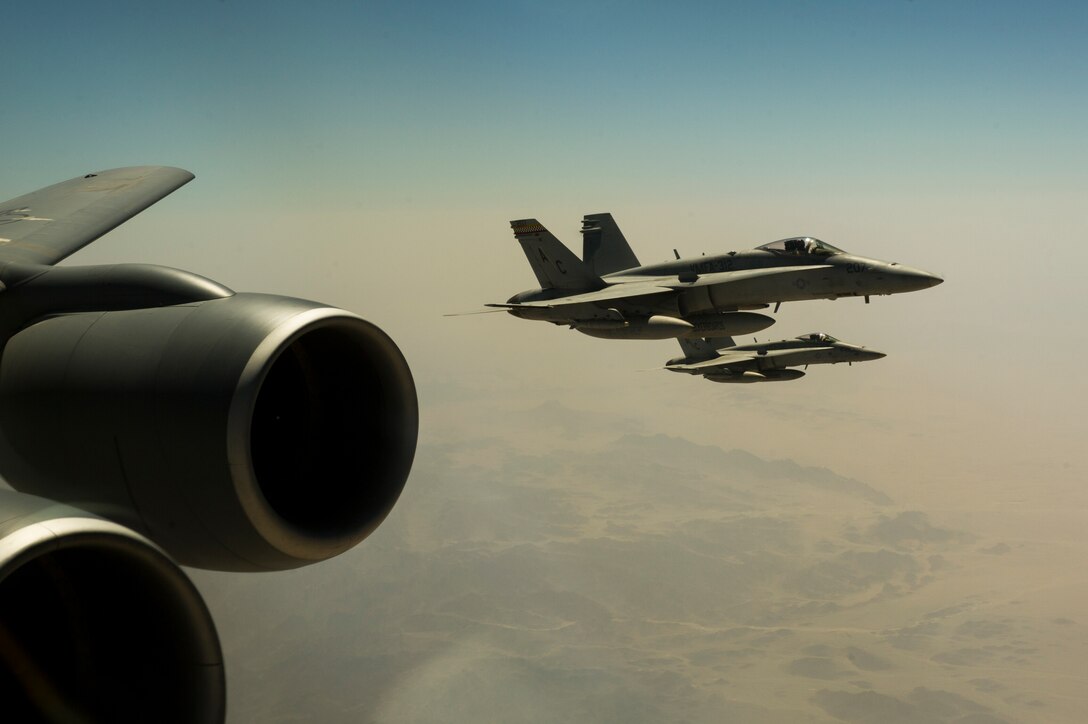 U.S. Navy F/A-18C Hornets wait to receive fuel from a 340th Expeditionary Air Refueling Squadron KC-135 Stratotanker Sept. 4, 2013, over Afghanistan. The Hornets, based on aircraft carrier USS Harry Truman (CVN 68), deploy in support of Operation Enduring Freedom. (U.S. Air Force photo by SSgt Stephany Richards)
