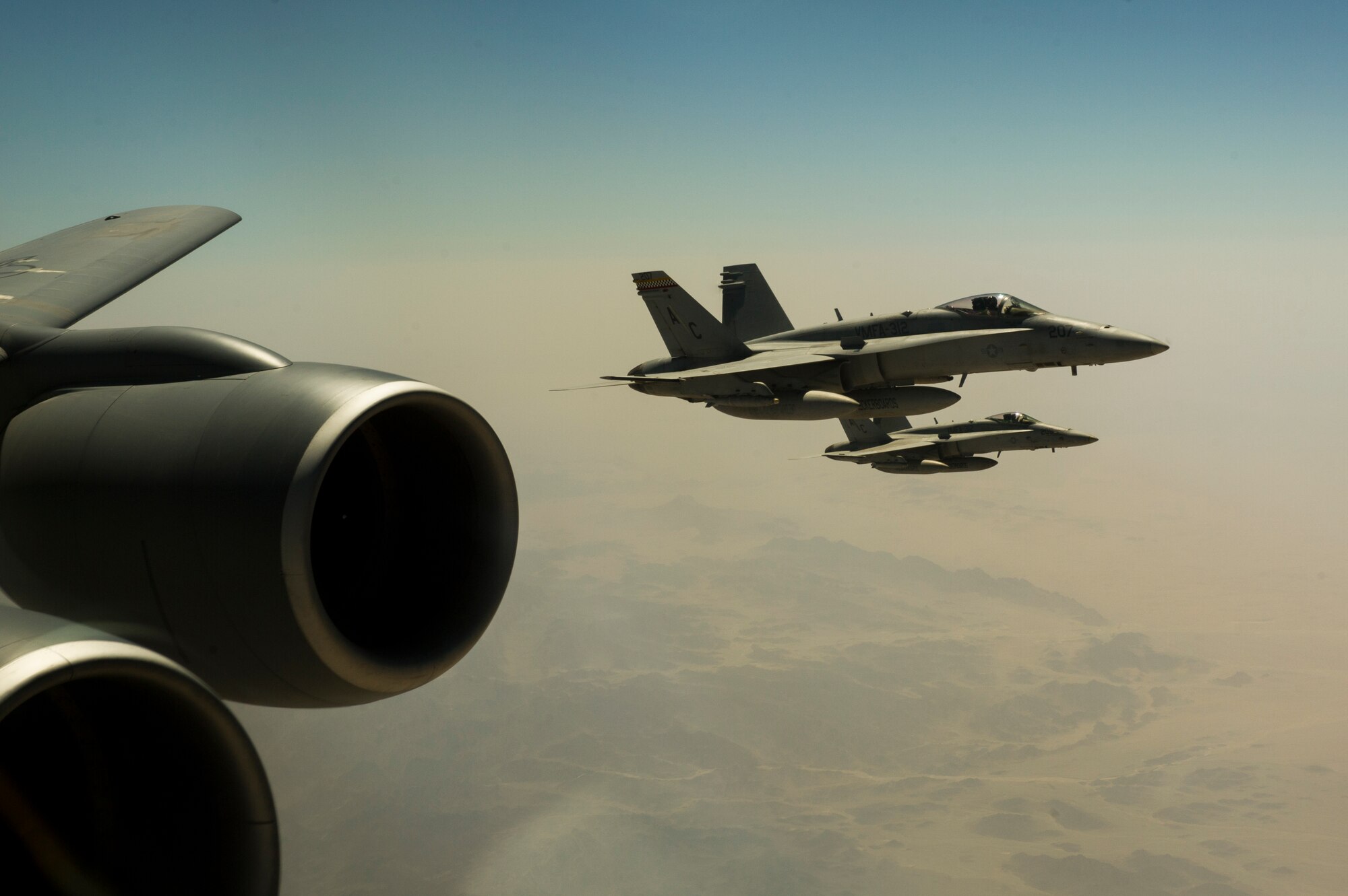 U.S. Navy F/A-18C Hornets wait to receive fuel from a 340th Expeditionary Air Refueling Squadron KC-135 Stratotanker Sept. 4, 2013, over Afghanistan. The Hornets, based on aircraft carrier USS Harry Truman (CVN 68), deploy in support of Operation Enduring Freedom. (U.S. Air Force photo by SSgt Stephany Richards)
