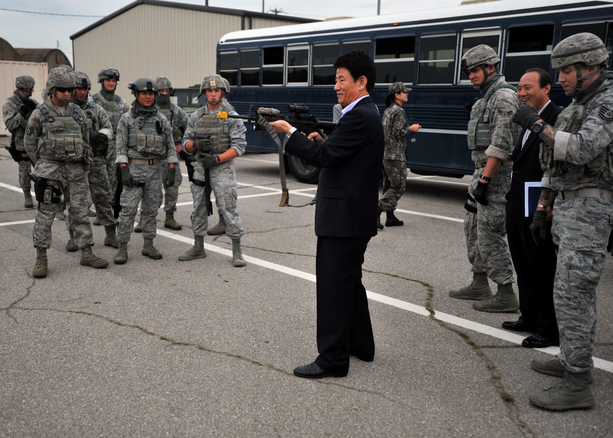 A Korean National Police official fires an M-4 rifle during a KNP tour of the 51st Security Forces Squadron at Osan Air Base, Republic of Korea, Sept. 6, 2013. During their visit, KNP members and their ROK air force counterparts got a first-hand look at the 51st SFS’s capabilities, and participated in hands-on live-fire weapon simulation training. (U.S. Air Force photo/Senior Airman Siuta B. Ika)