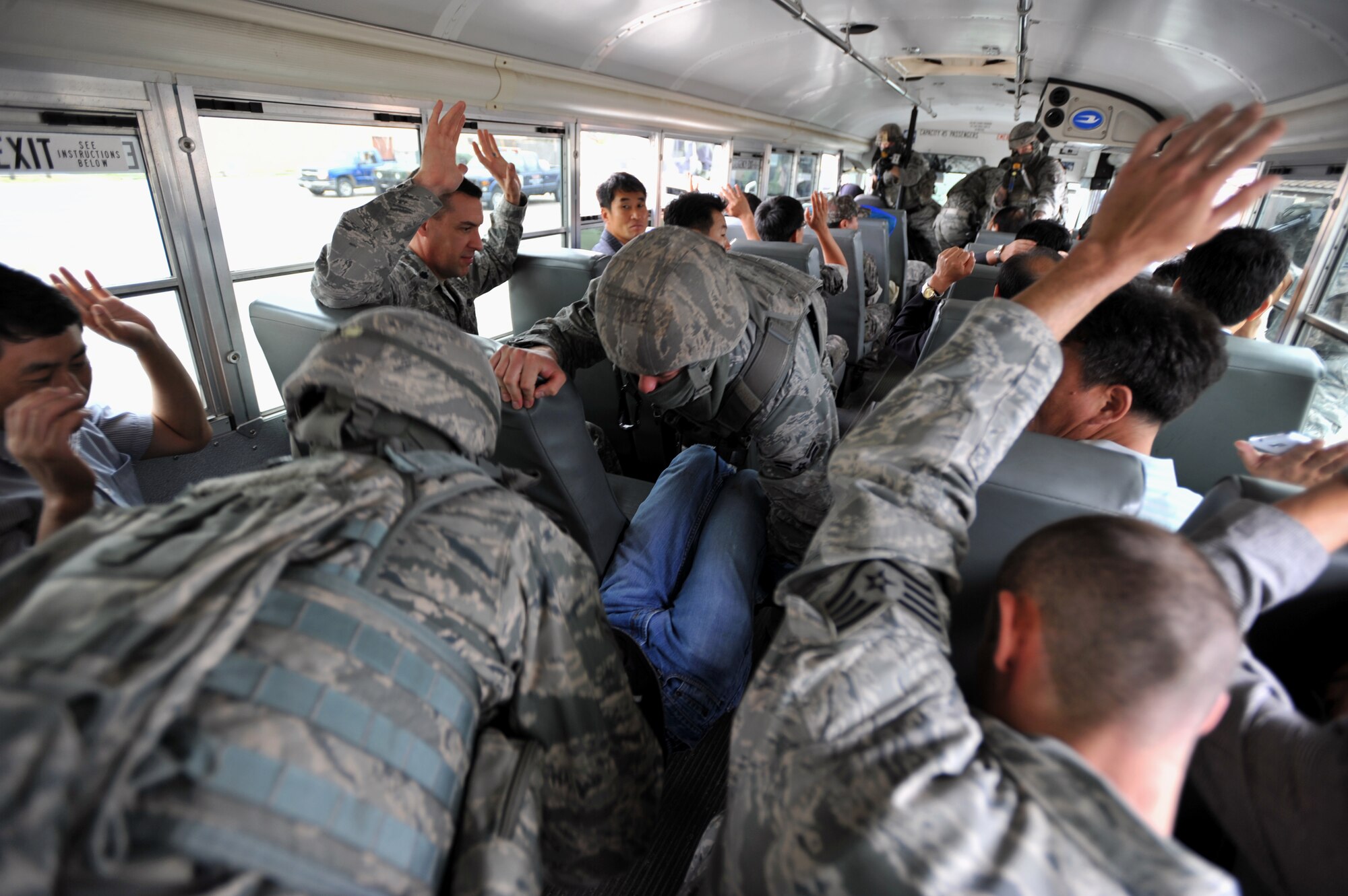 Members of the 51st Security Forces Squadron Quick Reaction Team apprehend an assailant during a QRT demonstration during a Korean National Police tour of the 51st SFS at Osan Air Base, Republic of Korea, Sept. 6, 2013. The 51st SFS hosted the KNP officials and ROK air force security forces members to showcase their capabilities and foster a healthy working relationship between the three agencies. (U.S. Air Force photo/Senior Airman Siuta B. Ika)