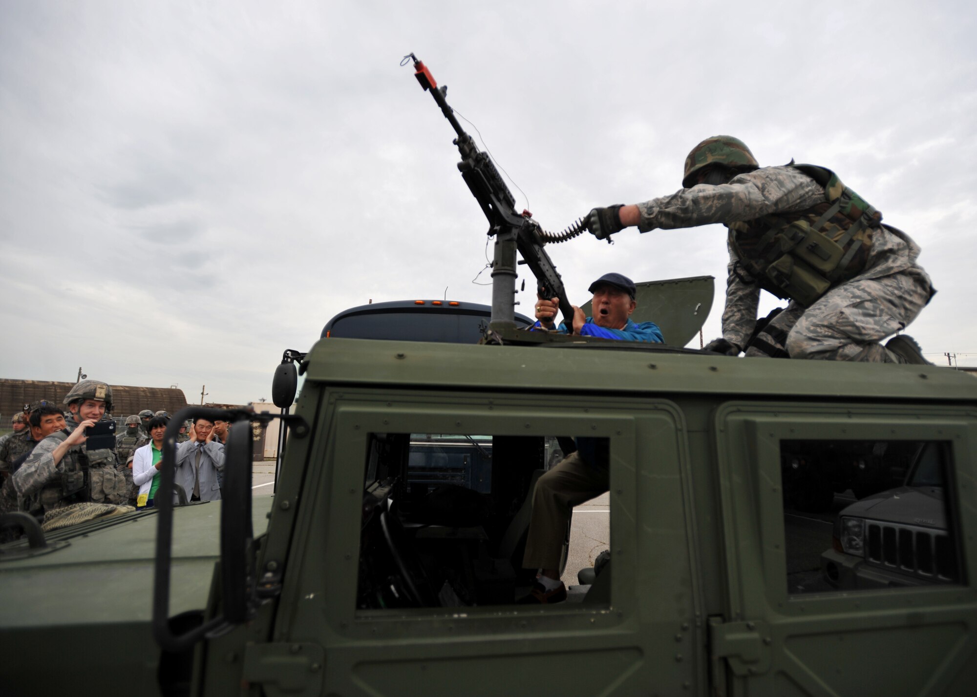 A Korean National Police official fires a gun from a Humvee during a KNP tour of the 51st Security Forces Squadron at Osan Air Base, Republic of Korea, Sept. 6, 2013. The 51st SFS hosted the KNP officials and ROK air force security forces members to showcase their capabilities and foster a healthy working relationship between the three agencies. (U.S. Air Force photo/Senior Airman Siuta B. Ika)