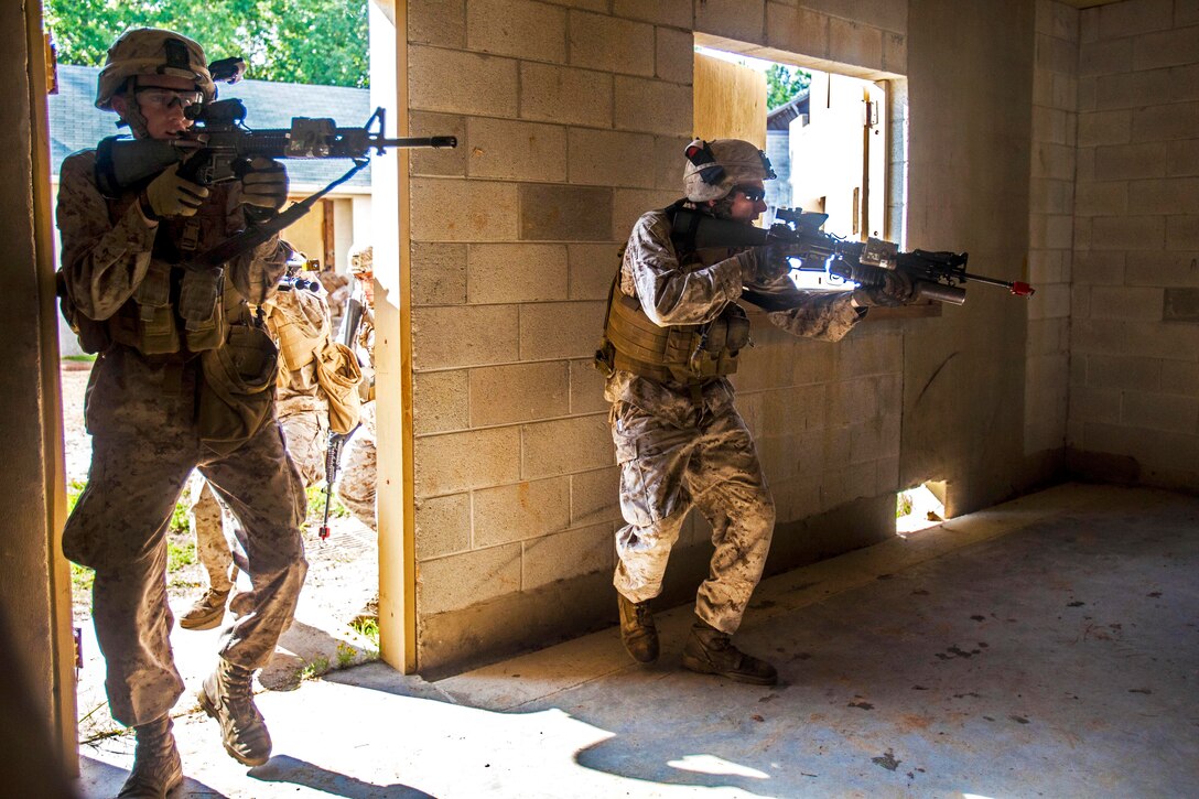 Marine Corps Lance Cpl. Aaron Edwards, right, and Marine Pvt. Perry Hill practice clearing a room during urban tactics training, part of the Realistic Urban Training exercise, on Fort Pickett, Va., Aug. 30, 2013. Edwards, a grenadier, and Hill, a rifleman, are assigned to Battalion Landing Team, 1st Battalion, 6th Marine Regiment, 22nd Marine Expeditionary Unit. 