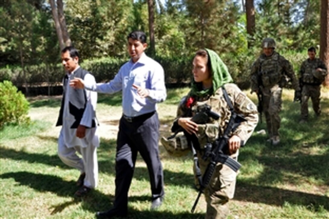 U.S. Army Capt. Jennifer Leathers, right, discusses a solar-powered water pump project with Manan Matin, center, director of the Directorate of Agriculture, Irrigation and Livestock, during a meeting in Farah City, Afghanistan, Sept. 5, 2013. Leathers, a civil affairs officer, is assigned to Provincial Reconstruction Team Farah.