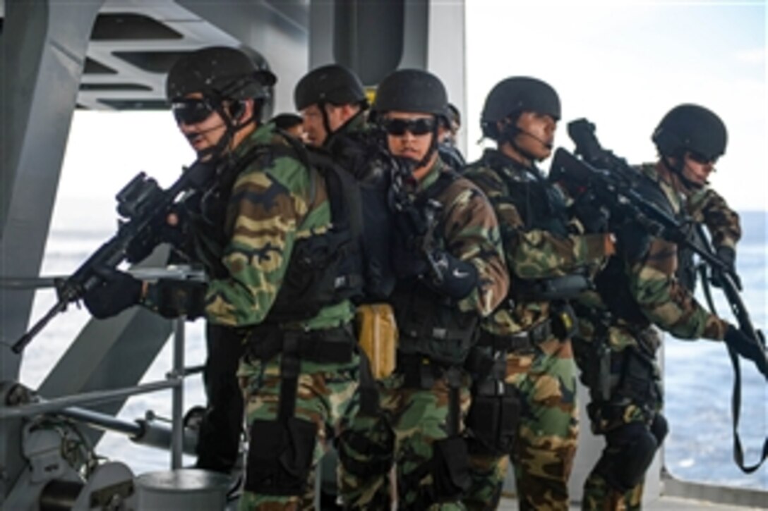Members from the USS Freedom’s visit, board, search and seizure team board a Brunei navy ship during Southeast Asia Cooperation and Training, an annual exercise in the South China Sea, Sept. 7, 2013. The exercise, which includes navy liaison officers from Brunei, Indonesia, Malaysia, the Philippines, Singapore, Thailand and the United States, tracks vessels of interest in the maritime interdiction scenario.