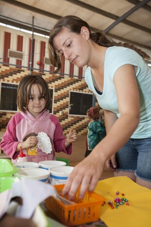 Cpl. Stephenie Stombaugh, a motor transportation operator with Marine Wing Support Squadron 171, Marine Aircraft Group 12, 1st Marine Aircraft Wing, III Marine Expeditionary Force, helps a student with an arts-and-crafts project at the Macfarlane Elementary School in Katherine, Australia, during a community relations event Aug. 16, 2013. The Marines are scheduled to visit the school and work with students twice a week for the duration of Exercise Southern Frontier. 