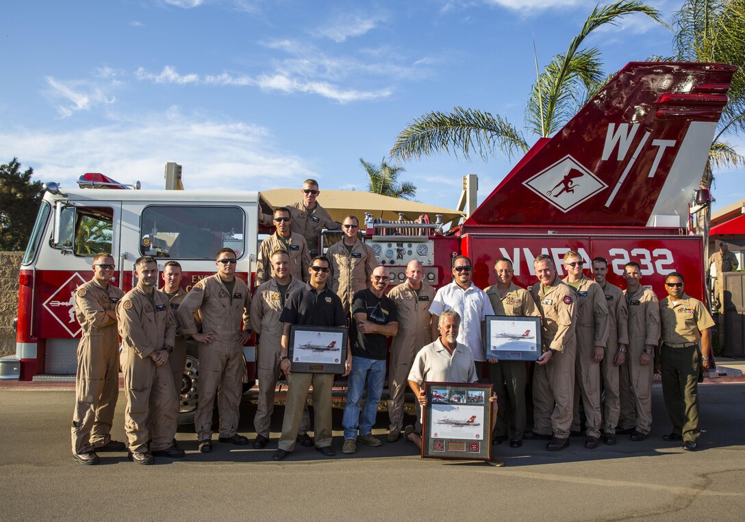 Marines stand with Brandon Wilson, sixth from the left, Dave Largent, seventh from the left, Gyan Evans, ninth from the left, Jimmy Gillan, kneeling, in front of the Fighter Truck, Marine Fighter Attack Squadron 232’s squadron vehicle, during a sendoff for Marine Fighter Attack Squadron 232 and Marine Fighter Attack Squadron (All Weather) 225 at the Officers’ Club aboard Marine Corps Air Station Miramar, Calif., Sep. 6. All four helped VMFA-232 complete this project.