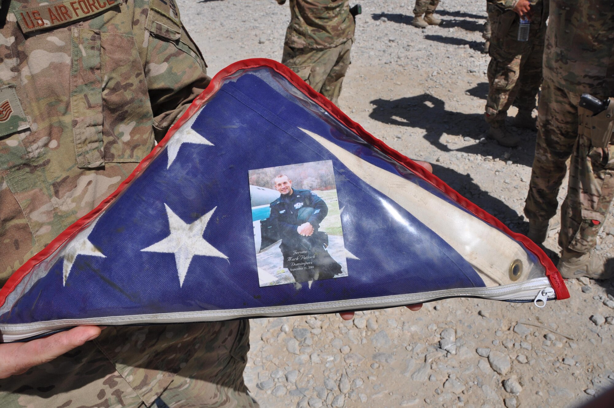 Staff Sgt. Jerome Dominguez from the 105th Security Forces Squadron at Stewart Air National Guard Base in Newburgh, New York, was among those killed at the site of the World Trade Center Sept. 11, 2001. As an initial responder to the attacks, he was killed while evacuating people from the interior of WTC Tower No. 2 when it collapsed. While 12 years have passed since the attack of Sept. 11, deployed members from the 105th SFS keep the memory of their comrade alive by carrying an encased folded flag with a picture of Dominguez. (Courtesy photo)