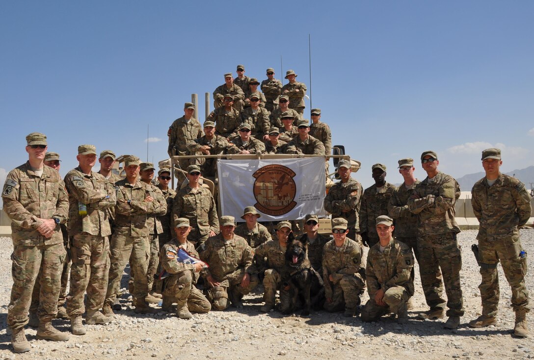 Members of the 105th Security Forces Squadron deployed from Stewart Air National Guard Base in Newburgh, New York, gather for a group photo Sept. 8, 2013, at Bagram Airfield, Afghanistan. Sept. 11, 2001, is never too far from the hearts and minds of the 105th SFS. Through mementos and each other, they remember one unit member who was killed during the attacks of Sept. 11, 2001. (U.S. Air Force photo/Tech. Sgt. Rob Hazelett)