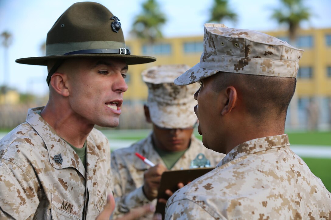 Sgt. Anthony May, drill instructor, Company F, 2nd Recruit Training Battalion, inspects a recruit of Co. F on his recruit knowledge, weapon cleanliness, and uniform appearance during the senior drill instructor inspection aboard Marine Corps Recruit Depot San Diego, Aug. 23.  This inspection will set recruits up for success for their future inspections, including the battalion commander’s inspection, which is a graduation requirement.