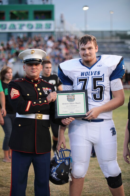 Aaron Hiedman, a player with the Basic High School Wolves, is awarded the Student Athlete Award before the game against Green Valley High School in Henderson, NV., Sept. 7, 2013. Sgt. Billy Carroll, a Marine recruiter with Recruiting Sub-Station Las Vegas presented Heidman with the award for his contributions on and off the field.