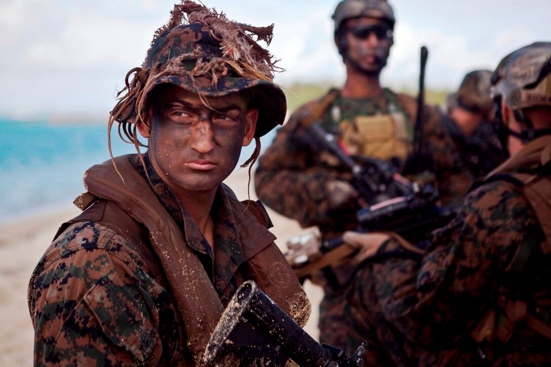 Lance Corporal Eric Sundquist of battalion landing team 2/4's Maritime Raid Force Platoon (Fox Co, 3rd Plt) waits on a shore of Australia. A BLT is the ground combat aspect of the Marine Expeditionary Unit.