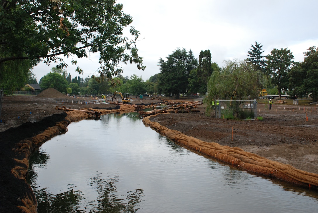 Water flows in the newly constructed channel in Crystal Springs Creek. The new stream channel in Westmoreland Park contains deep and shallow areas, known as pools and riffles, as well as large trees and wood, placed intentionally to provide habitat for fish and wildlife. The Westmoreland Park ecosystem restoration is being accomplished in partnership with the city of Portland.