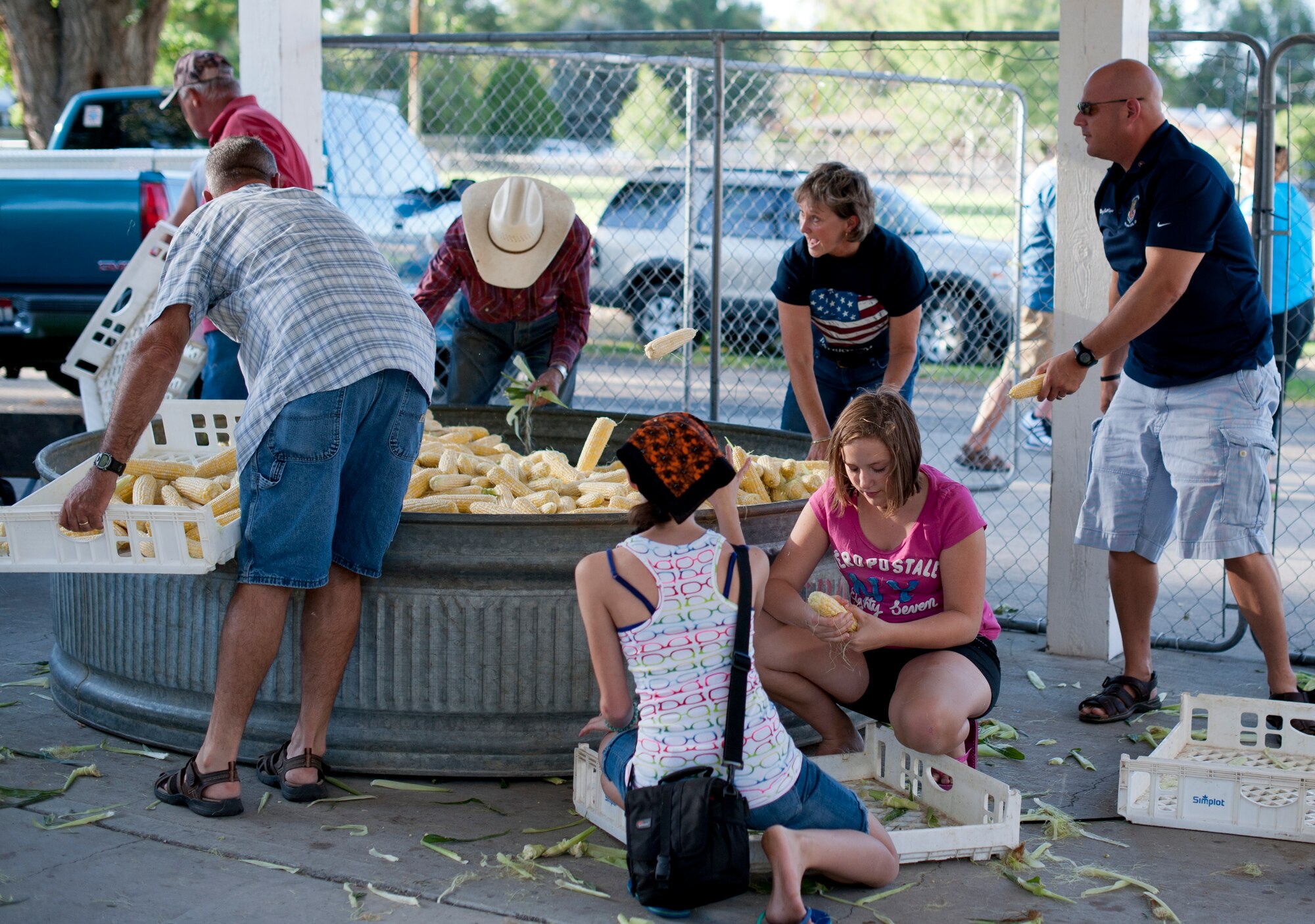 Military and community members gather shucked corn Sep. 6, 2013, at Carl Miller Park in Mountain Home, Idaho. Corn shucking is a traditional event in the annual Air Force Appreciation Days. This year marks the 53rd anniversary of the celebration. (U.S. Air Force photo by Airman 1st Class Brittany A. Chase/Released) 