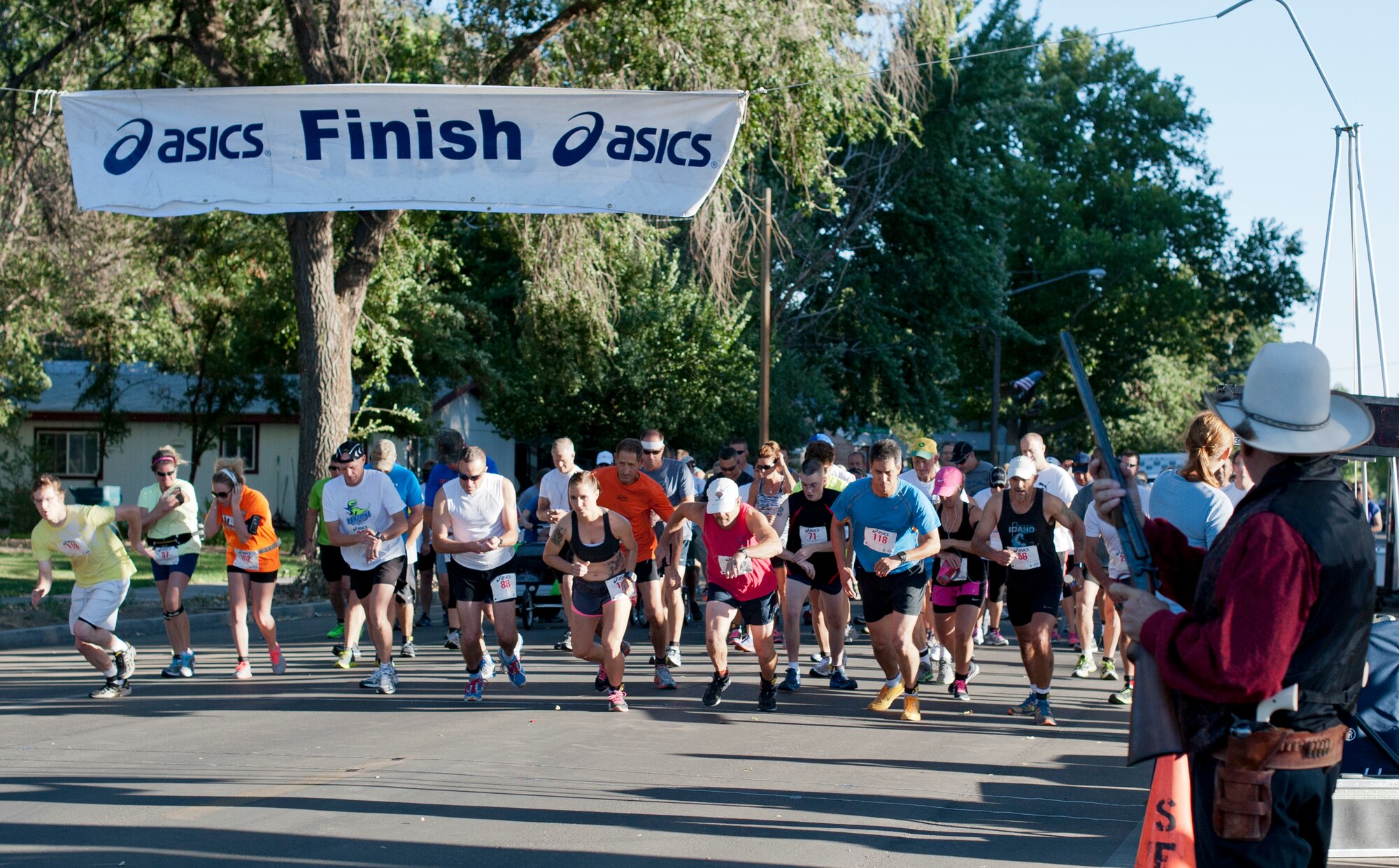 Gunfighters and community members start a race Sep. 6, 2013, at Carl Miller Park in Mountain Home, Idaho. Laurel McMahan, centered in the front row, took first-place in the 2013 Air Force Appreciation Five-Miler. (U.S. Air Force photo by Airman 1st Class Brittany A. Chase/Released)