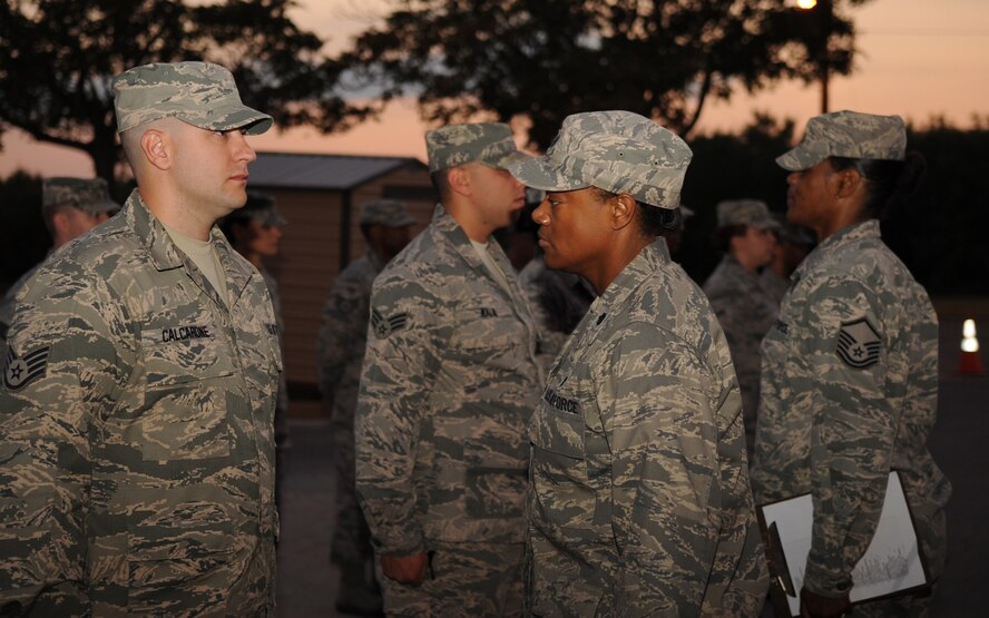 U.S. Air Force Lt. Col. Pagerine Jackson, right, inspects the uniform of Staff Sgt. Adam Calcarone, both from the 7th Medical Support Squadron, during an open ranks inspection Sept. 5, 2013, at the medical facility on Dyess Air Force Base, Texas.  Airmen are taught open ranks inspections during basic military training, but they are conducted Air Force wide to ensure Airmen are complying with proper military standards. Since changes to the uniforms can come at any time, this inspection ensures everyone is up-to-date with the most current regulations. (U.S. Air Force photo by Senior Airman Shannon Hall/Released)