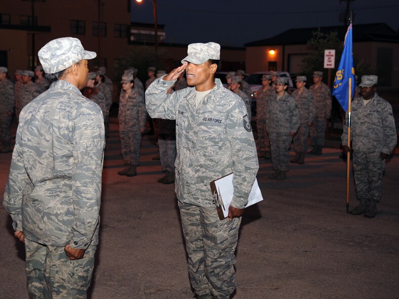 U.S. Air Force Master Sgt. Annette Collins, right, renders a salute to Lt. Col. Pagerine Jackson, both from the  7th Medical Support Squadron, during an open ranks inspection Sept. 5, 2013, at the medical facility on Dyess Air Force Base, Texas. Open ranks are performed to ensure Airmen are complying with correct dress and appearance standards and proper military bearing. This is one of the most efficient ways to instill professionalism within Airmen. (U.S. Air Force photo by Senior Airman Shannon Hall/Released)