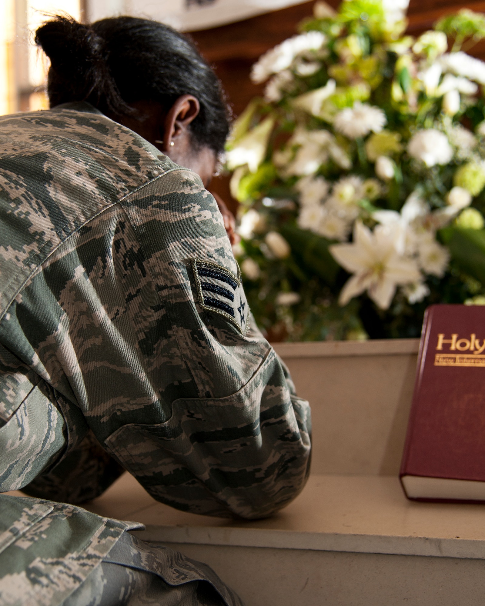 An Air Force senior airman prays and recalls the challenges she’s endured at a base chapel in an undisclosed location. The Airman is a rape survivor and is a victim advocate in the base sexual assault prevention and response program. (U.S. Air Force photo by Master Sgt. Kevin Wallace/RELEASED)
