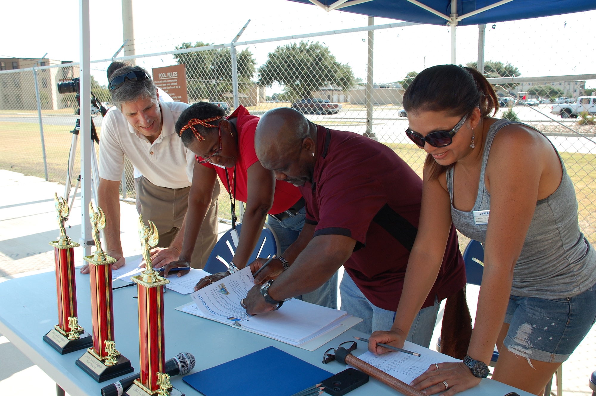 JOINT BASE SAN ANTONIO-LACKLAND, Texas – From left, Arnold Hall staff members Brian Milkovich, Gloria Singleton, Percy Lewis and Susana Salazar deliberate to decide the winners of the Titanic, Most Creative and Ugliest Boat Awards. (U.S. Air Force photo/Debbie Aragon)