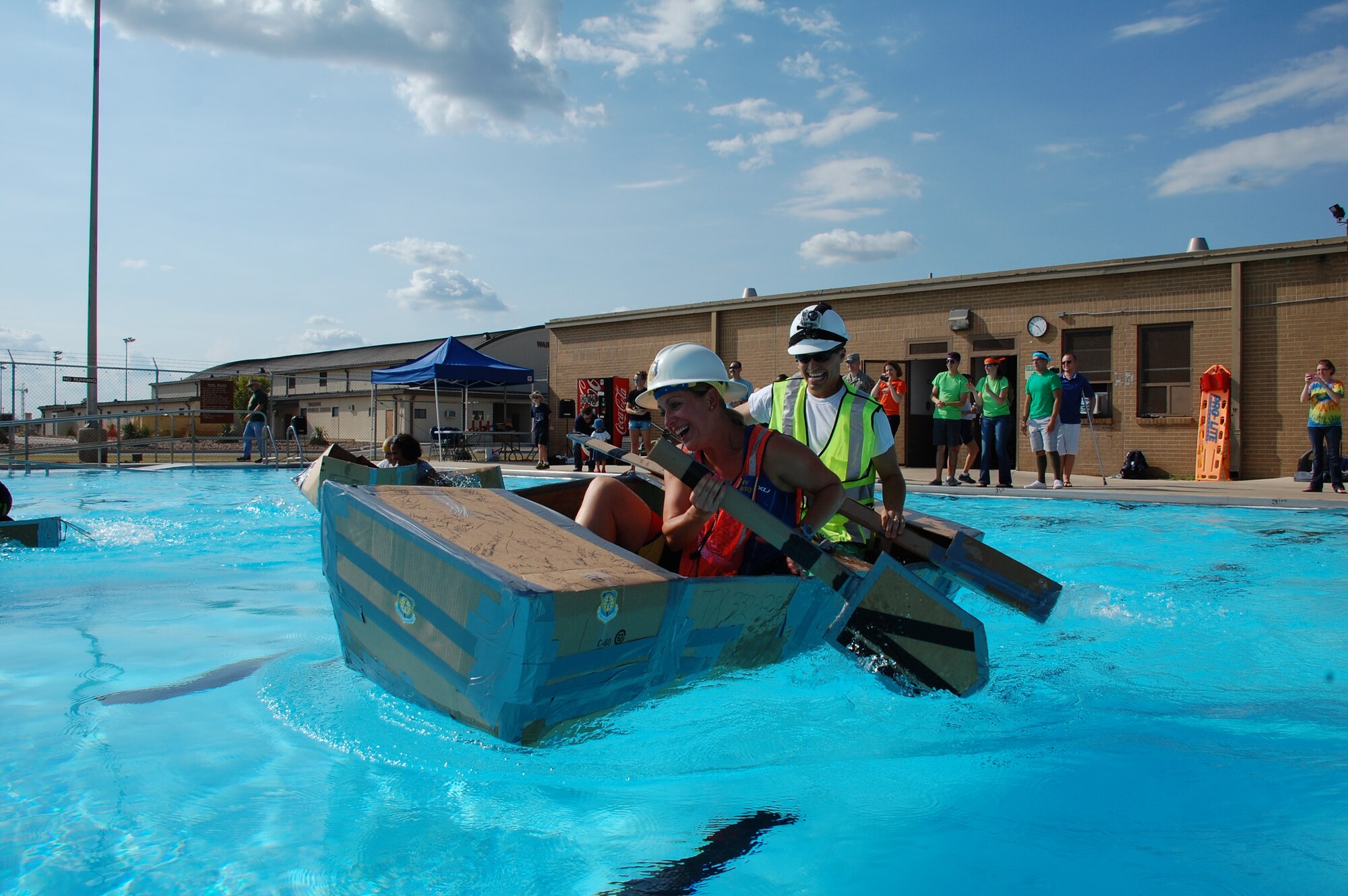 JOINT BASE SAN ANTONIO-LACKLAND, Texas -- Air Force Civil Engineer Center Argonauts First Mate Tonda Sallee and Captain Capt. Graham Auten paddle their way across the Warhawk pool Sept. 6 during the 2013 Lackland Cardboard Boat Regatta. (U.S. Air Force photo/Debbie Aragon)