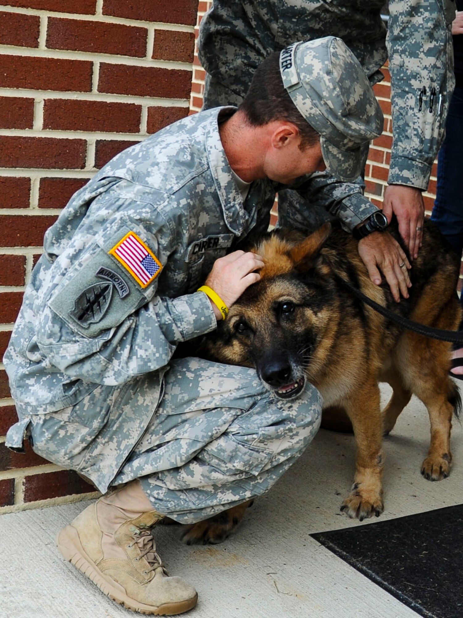 Duuk, 3rd Military Police Detachment explosives detection military working dog, receives his goodbyes at Fort Eustis, Va., Sept. 9, 2013. Duuk was adopted by Andrew Lou, Newport News Police Department detective, after Lou heard about Duuk’s service history. (U.S. Air Force photo by Airman 1st Class Austin Harvill/Released)