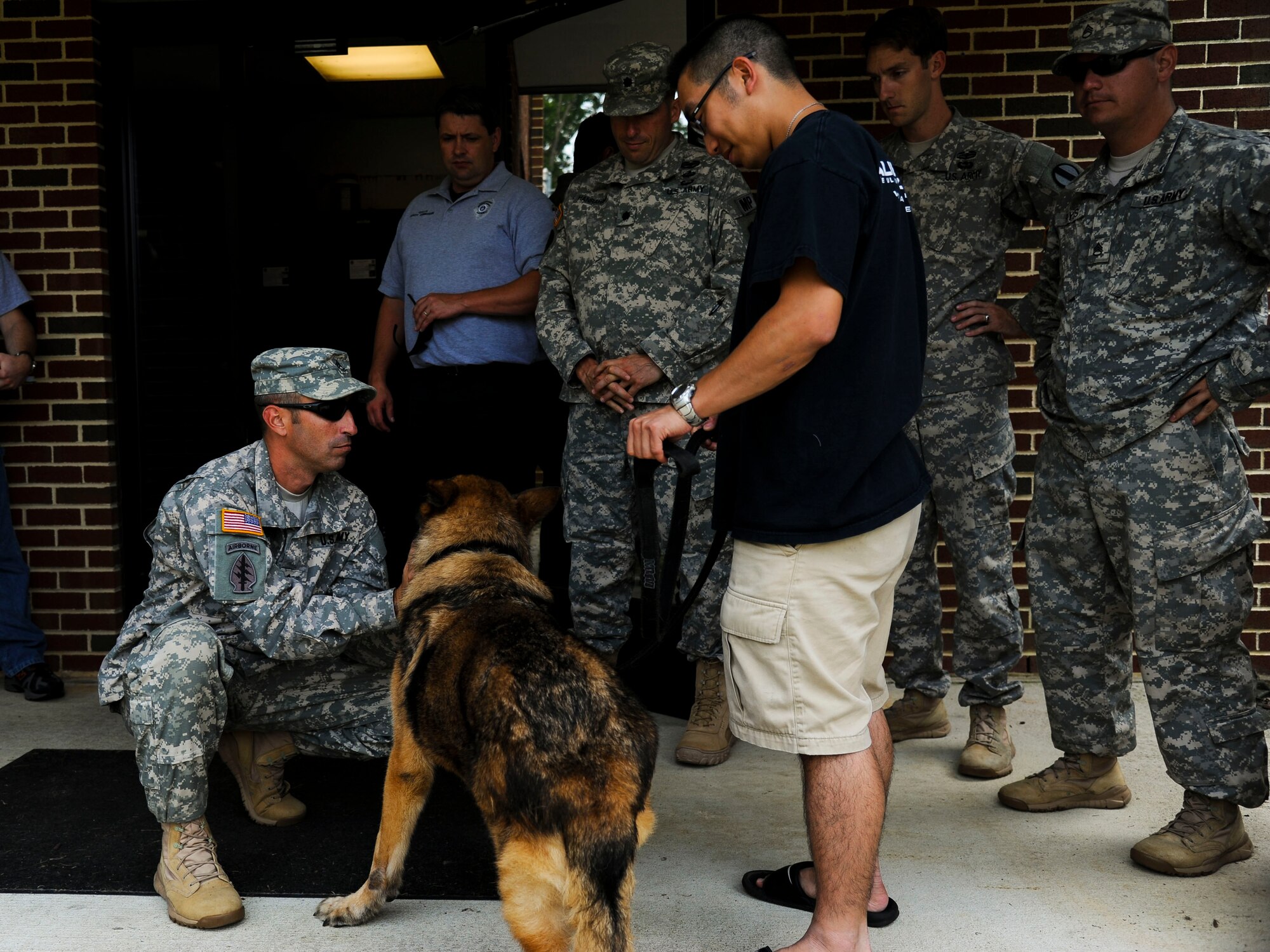 Duuk, 3rd Military Police Detachment explosives detection military working dog, receives his final goodbyes from Soldiers of the 3rd MP Det after being adopted at Fort Eustis, Va., Sept. 9, 2013. MWDs usually serve up to 10 years before retiring, when they are then eligible for a screening process to be considered for adoption. (U.S. Air Force photo by Airman 1st Class Austin Harvill/Released)