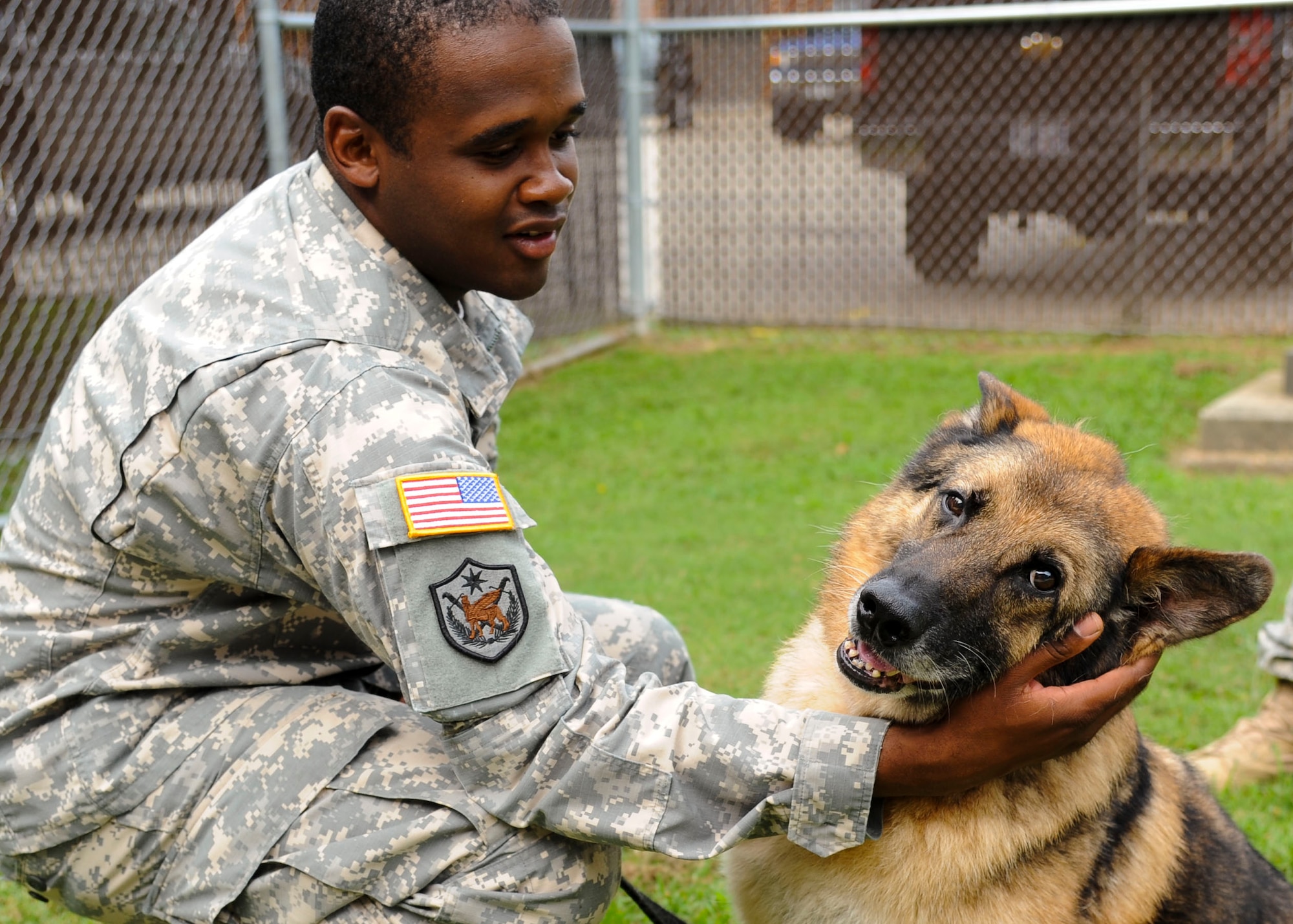 U.S. Army Sgt. Clevaun Fluellen, 3rd Military Police Detachment dog handler, says his goodbyes to Duuk, 3rd MP Det explosives detection military working dog at Fort Eustis, Va., Sept. 9, 2013. Duuk was adopted after eight years of military service. (U.S. Air Force photo by Airman 1st Class Austin Harvill/Released)