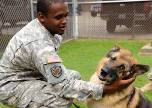 U.S. Army Sgt. Clevaun Fluellen, 3rd Military Police Detachment dog handler, says his goodbyes to Duuk, 3rd MP Det explosives detection military working dog at Fort Eustis, Va., Sept. 9, 2013. Duuk was adopted after eight years of military service. (U.S. Air Force photo by Airman 1st Class Austin Harvill/Released)