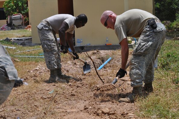 U.S. Air Force Staff Sgts. Maynard Foster and Jason Leal, plumbers from18th Civil Engineer Squadron, Kadena Air Base, Okinawa, Japan, cover water pipes they installed for Operation Pacific Angel 13-5 Cambodia at the health center in Rominh Sept. 9, 2013. This is the first day of the six-day operation. Thirty-six U.S. forces and Royal Cambodia Armed Forces worked together on three health centers during engineering civil action programs. PACANGEL is a joint and combined humanitarian assistance operation held in various countries several times a year and includes medical, dental, optometry, and engineering support programs and various subject-matter expert exchanges. (U.S. Air Force photo/Senior Master Sgt. Allison Day)