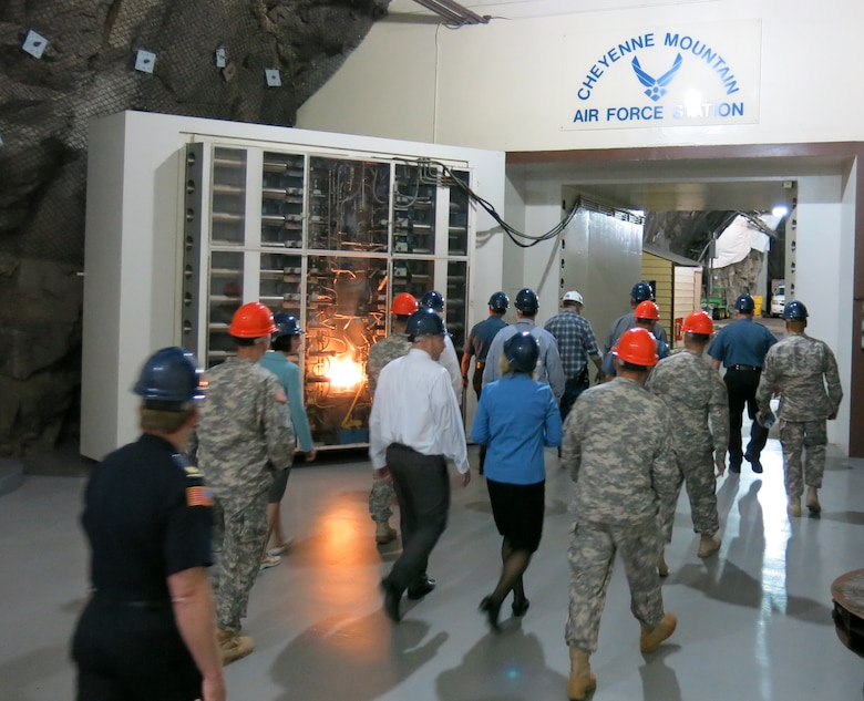 CHEYENNE MOUNTAIN AIR FORCE STATION, Colo. – Police chiefs and law enforcement department heads from around the Pikes Peak region pass through the entry-way of the second blast door during their tour of Cheyenne Mountain Air Force Station. (U.S. Air Force photo/Michael Golembesky)