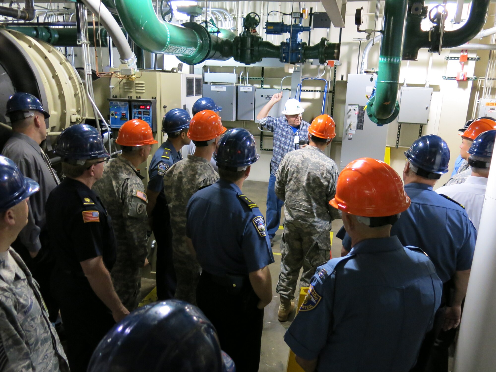 CHEYENNE MOUNTAIN AIR FORCE STATION, Colo. – Earl Clelland, 721st Civil Engineer Squadron power systems mechanic, talks to the tour group about some of the internal workings that keeps Cheyenne Mountain up and running. (U.S. Air Force photo/Michael Golembesky)