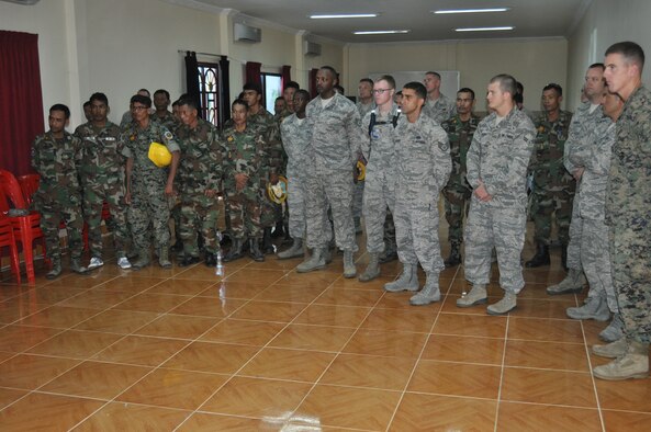 Royal Cambodia Air Forces and U.S. forces gather together Sept 8 for a safety briefing prior to beginning of Pacific Angel 13-5 Cambodia. Sixteen U.S. forces engineers will work alongside 20 Royal Cambodia Armed Forces engineers to renovate three health centers in Takeo. PACANGEL is a joint and combined humanitarian assistance operation held in various countries several times a year and includes medical, dental, optometry, and engineering support programs and various subject-matter expert exchanges. (U.S. Air Force photo/ Senior Master Sgt. Allison Day)