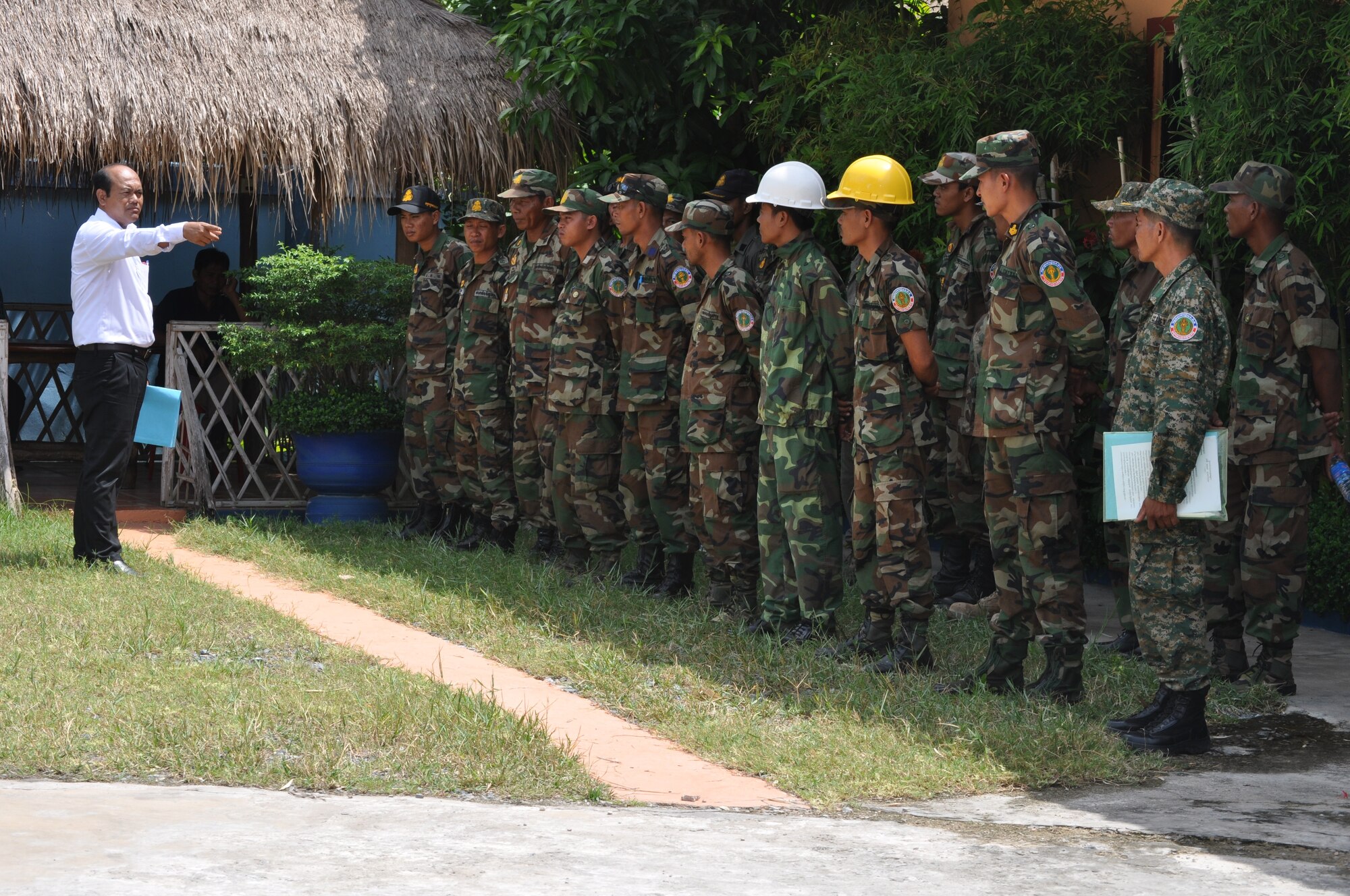 Lt. Col. San Savoeun from Engineering High Command, Headquarters, Deputy Demining Office in Phnom Penh, Cambodia and lead engineer for Royal Cambodia Armed Forces during Operation Pacific Angel 13-5 briefs his personnel shortly after their arrival in Takeo. Twenty engineers from the RCAF will work alongside 16 U.S. forces engineers to provide engineering assistance to three health centers here. PACANGEL is a joint and combined humanitarian assistance operation held in various countries several times a year and includes medical, dental, optometry, and engineering support programs and various subject-matter expert exchanges. (U.S. Air Force photo/Senior Master Sgt. Allison Day)