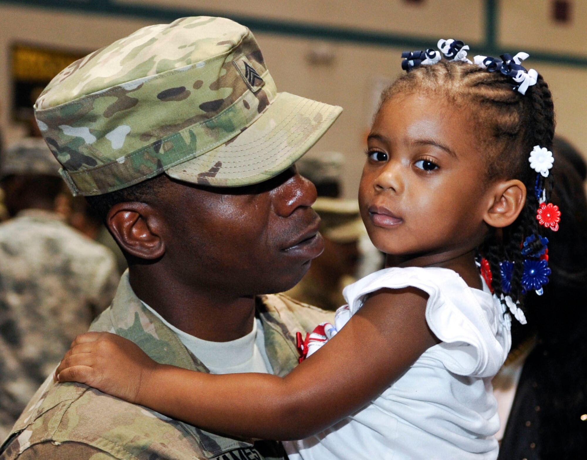 U.S. Army Sgt. Joseph James, a Soldier with the 359th Inland Cargo Transfer Company, holds his daughter, 2-year-old Naleah James, during a welcome-home ceremony for the 359th ICTC at Fort Eustis, Va., Sept. 9, 2013. The 359th ICTC is returning from a nine-month deployment. (U.S. Air Force photo by Staff Sgt. Wesley Farnsworth/Released)