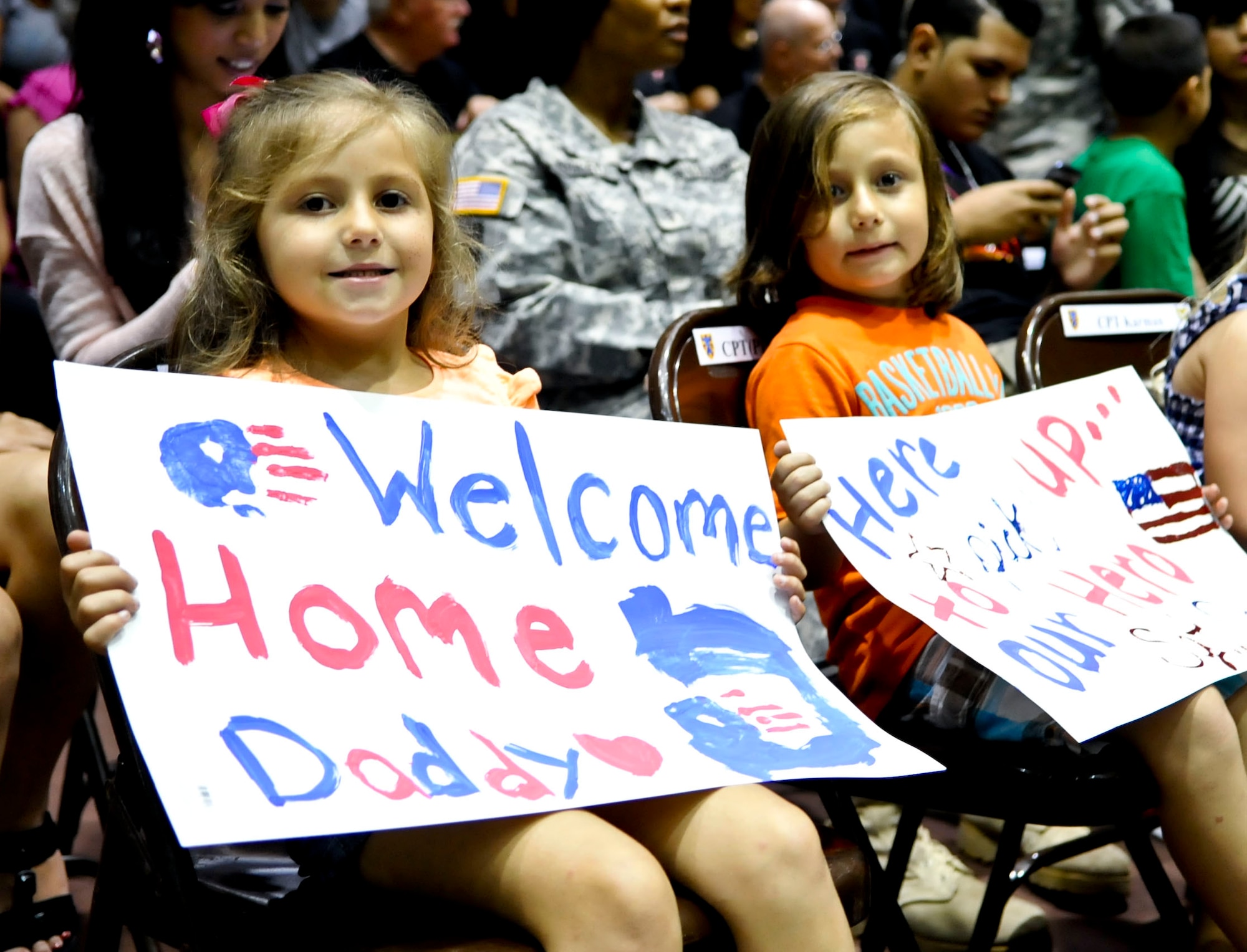 From left, 4-year-old Kylie Davis and 5-year-old Aiden Davis await the return of their father, U.S. Army Sgt. Luis Davis of the 359th Inland Cargo Transfer Company, during a welcome-home ceremony at Fort Eustis, Va., Sept. 9, 2013. The 359th ICTC recently completed a nine-month tour in Afghanistan. (U.S. Air Force photo by Staff Sgt. Wesley Farnsworth/Released)