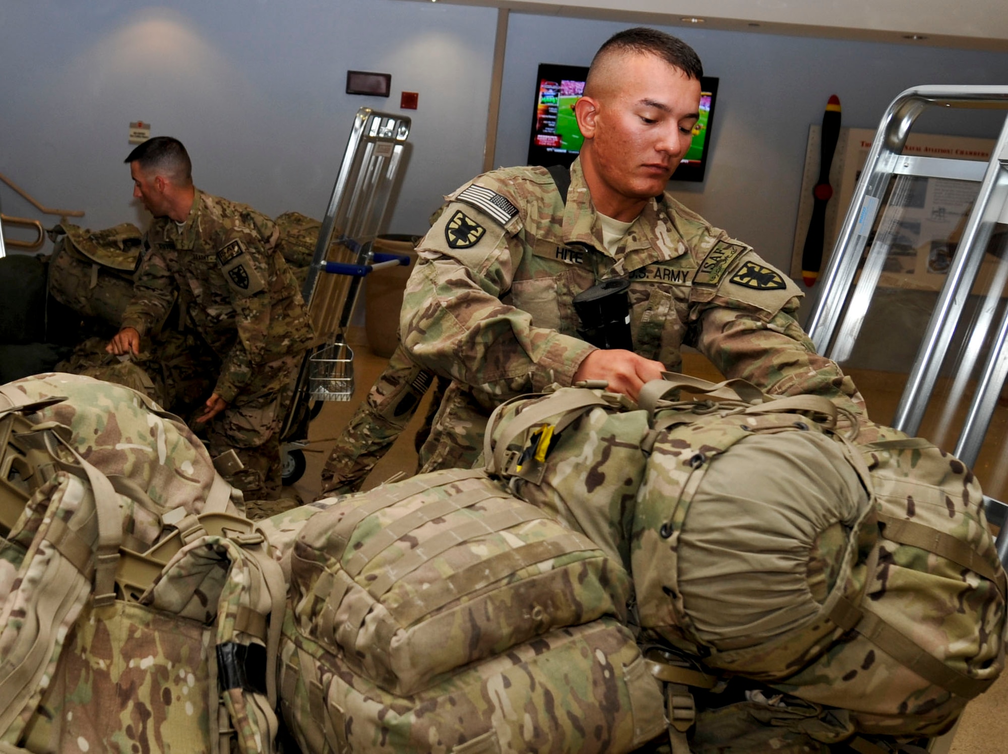 U.S. Army Pfc. John Hite, a Soldier with the 395th Inland Cargo Transfer Company, loads up a luggage cart full of gear inside the passenger terminal at Naval Station Norfolk, Sept. 9, 2013. The 359th ICTC conducted 62 missions across 480,000 miles, earned 17 Purple Hearts, 55 combat action badges and two battlefield promotions. (U.S. Air Force photo by Staff Sgt. Wesley Farnsworth/Released)
