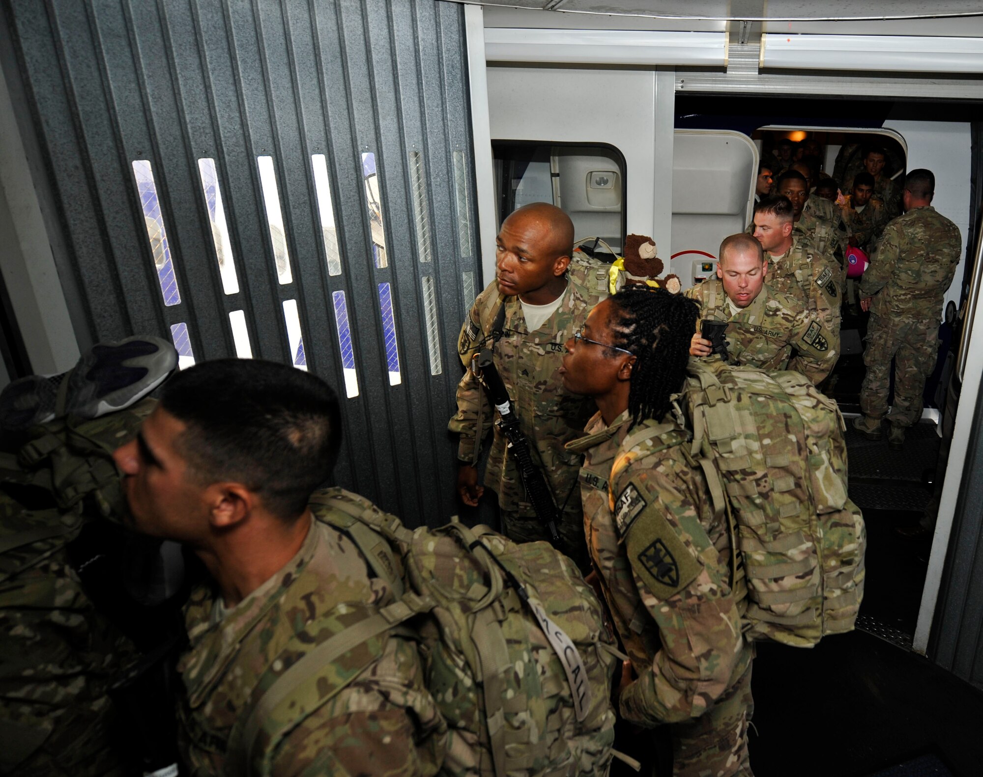 Members of the 359th Inland Cargo Transfer Company, 10th Transportation Battalion, 7th Sustainment Brigade, return home from deployment at Naval Station Norfolk, Sept. 9, 2013. The 359th ICTC conducted 62 missions across 480,000 miles, earned 17 Purple Hearts, 55 combat action badges and two battlefield promotions. (U.S. Air Force photo by Staff Sgt. Wesley Farnsworth/Released)