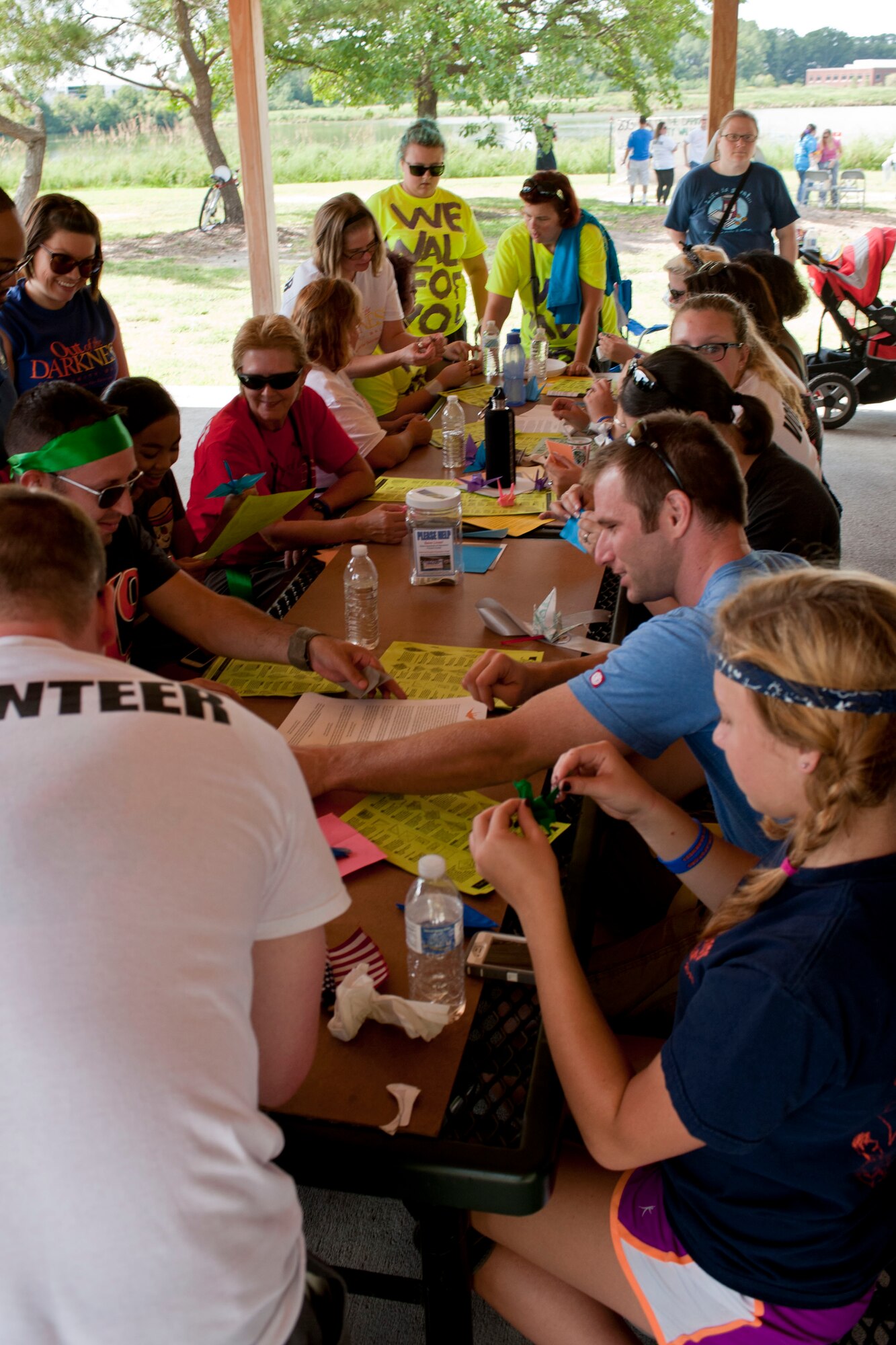 Volunteers and participants make paper cranes during the Out of Darkness suicide awareness walk in Virginia Beach, Va., Sept. 7, 2013. The cranes are used as a symbol of healing, happiness and hope. (U.S. Air Force photo by Staff Sgt. Stephanie Rubi/Released)