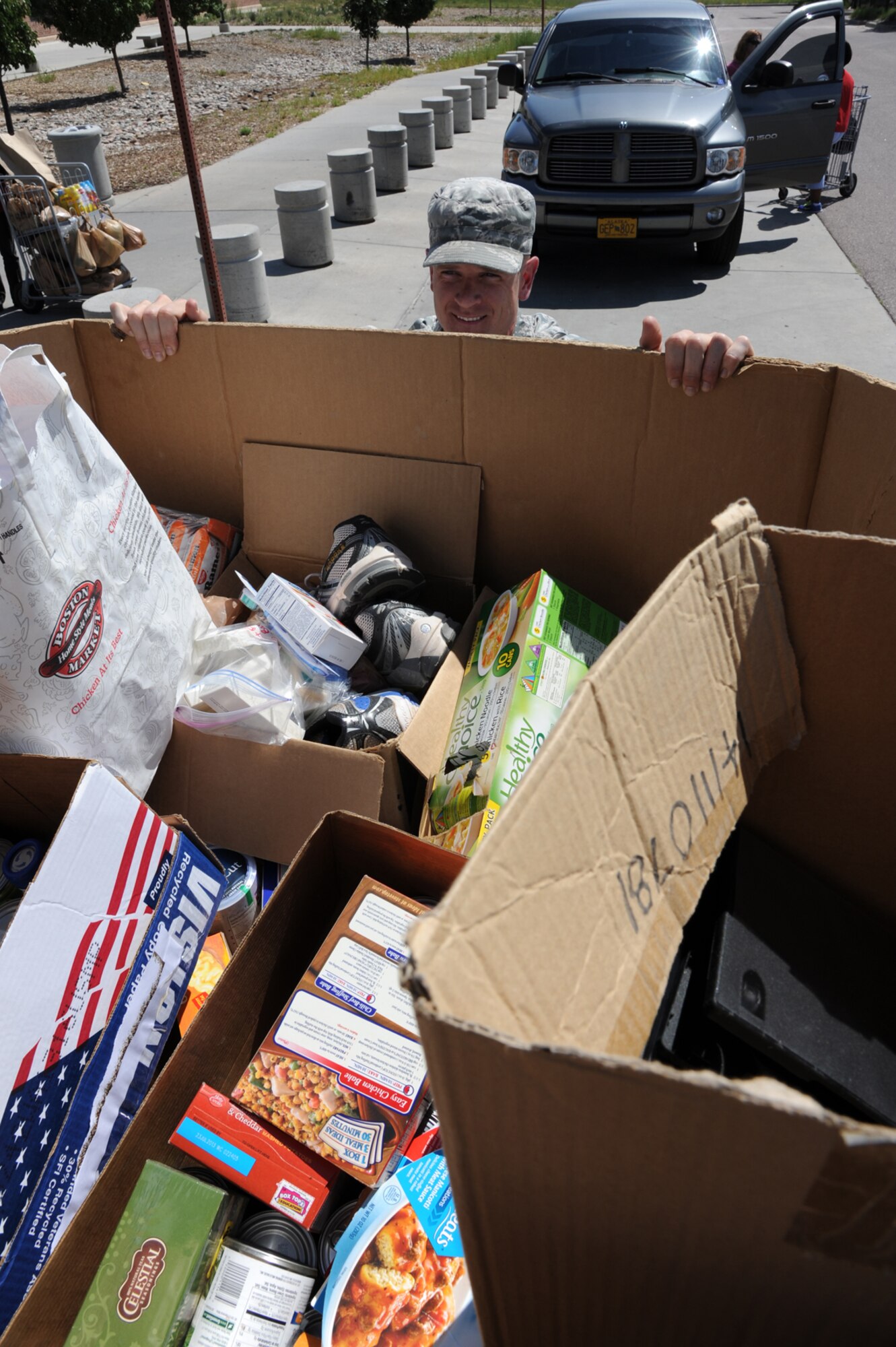 PETERSON AIR FORCE BASE, Colo. – Staff Sgt. Scott Devine, 21st Space Wing chaplain assistant, loads an oversized box of donations onto a flatbed truck as he collects donations from this year’s “Feds Feed Families” food drive. Team Pete donated more than 6,000 pounds of food items for needy families in the region during the drive. Feds Feed Families is a nationwide event that encourages federal employees to help fight hunger in America by donating nonperishable food items in their local area. Last year the program collected more than 7.2 million pounds of food nationwide. (U.S. Air Force photo/Staff Sgt. J. Aaron Breeden)