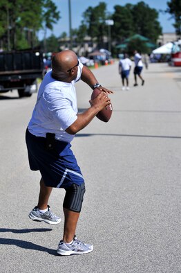 A U.S. Air Force Airman throws a football, in between events, during the 20th Mission Support Group Warrior Challenge, Shaw Air Force Base, S.C., Sept. 6, 2013. The 20th MSG Warrior Challenge, a day-long event meant to boost morale between Airmen and Soldiers, included softball, tug of war, a watermelon eating contest and other events to build camaraderie.  (U.S. Air Force photo by Airman 1st Class Jensen Stidham/Released)