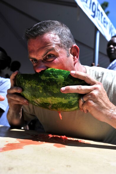A U.S. Air Force Airman eats watermelon while participating in a watermelon eating contest during the 20th Mission Support Group Warrior Challenge, Shaw Air Force Base, S.C., Sept. 6, 2013. The 20th MSG Warrior Challenge, a day-long event meant to boost morale between Airmen and Soldiers, included softball, tug of war, a watermelon eating contest and other events to build camaraderie.  (U.S. Air Force photo by Airman 1st Class Jensen Stidham/Released)
